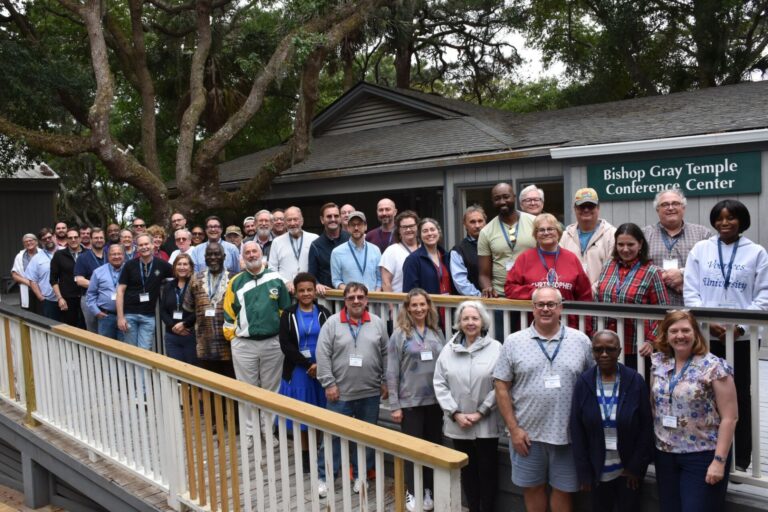 Clergy of the Episcopal Diocese of South Carolina stand with the bishop during a retreat at St. Christopher Camp and Conference Center in May 2026